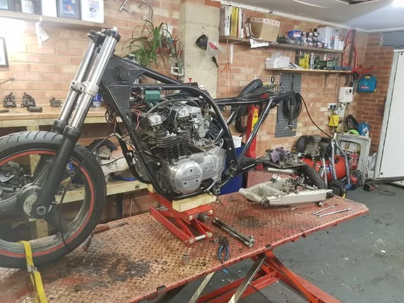 Motorcycle frame and engine during workshop rebuild