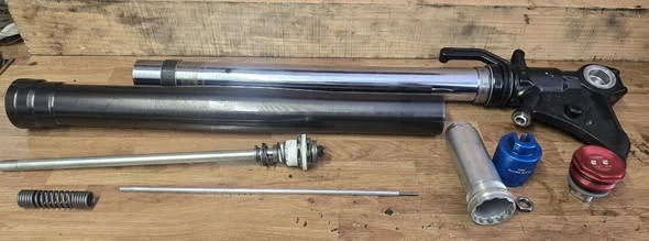 Motorcycle fork components laid out for servicing